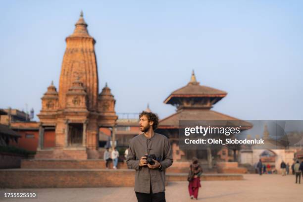 man with camera exploring bhaktapur - katmandu stock pictures, royalty-free photos & images