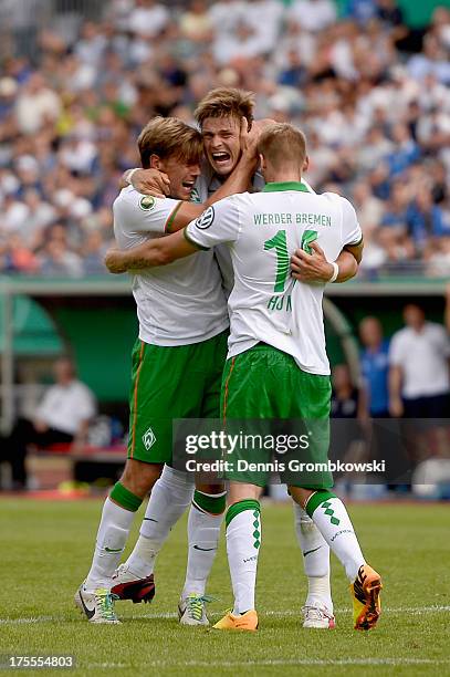 Sebastian Proedl of Werder Bremen celebrates with teammates after scoring his team's first goal during the DFB Cup first round match between 1. FC...