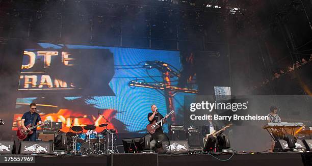 Band members of New Order perform during Lollapalooza 2013 at Grant Park on August 2, 2013 in Chicago, Illinois.