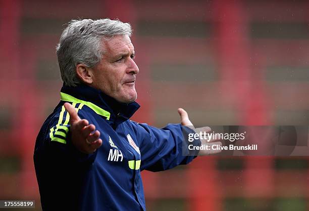 Stoke City manager Mark Hughes shows his frustrations as he watches his new team during the pre season friendly match between Wrexham AFC and Stoke...