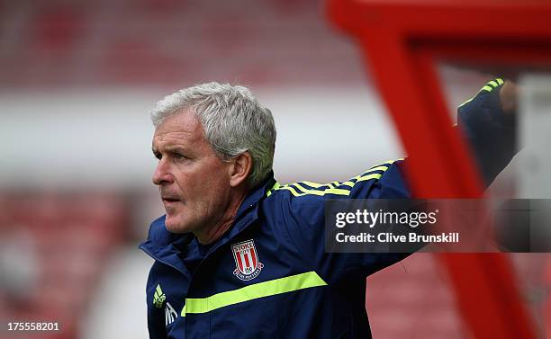 Stoke City manager Mark Hughes watches his new team during the pre season friendly match between Wrexham AFC and Stoke City at Racecourse Ground on...