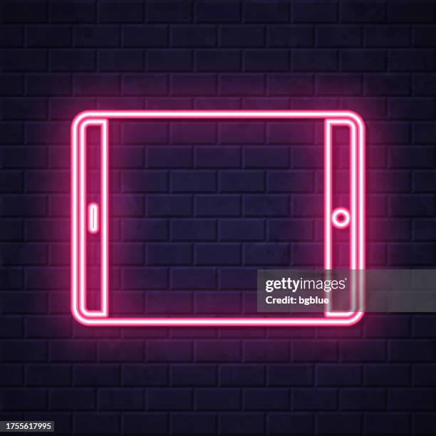 tablet pc - horizontal position. glowing neon icon on brick wall background - touch screen wall stock illustrations