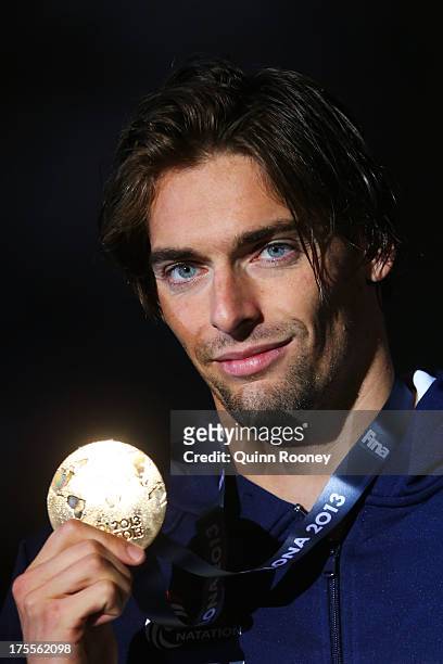Gold medal winner Camille Lacourt of France celebrates on the podium after the Men's Backstroke 50m Final on day sixteen of the 15th FINA World...