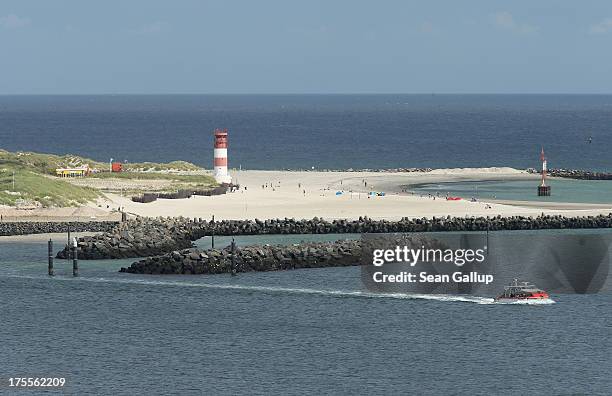 Ferry departs from Duene Island after delivering visitors on August 3, 2013 near Helgoland, Germany. Duene Island was once an extension of...