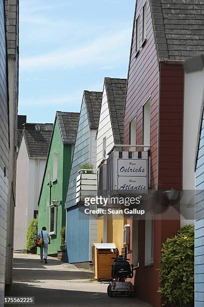 Man walks up a street past houses built after World War II in Helgoland town on August 3, 2013 on Heligoland Island, Germany. Heligoland Island, in...