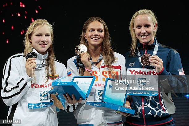 Silver medal winner Ruta Meilutyte of Lithuania, Gold medal winner Yuliya Efimova of Russia and Bronze medal winner Jessica Hardy of the USA...