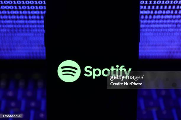 Binardy code displayed on a laptop screen and Spotify logo displayed on a phone screen are seen in this illustration photo taken in Krakow, Poland on...