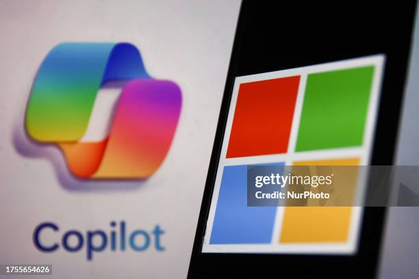 Copilot logo displayed on a laptop screen and Microsoft logo displayed on a phone screen are seen in this illustration photo taken in Krakow, Poland...