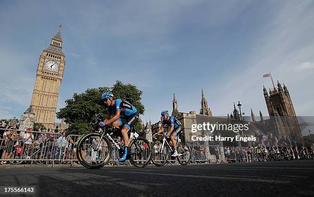 David Millar and Fabian Wegmann of team Garmin Sharp lead the peloton past the Houses of Parliament during the Prudential RideLondon-Surrey Classic...