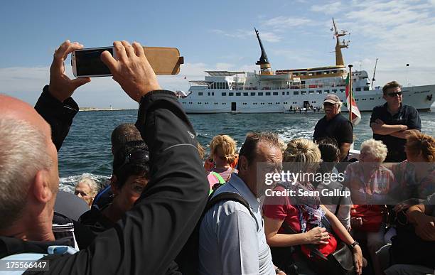 Summer tourists are ferried to Helgoland town from an arriving passenger ship on August 3, 2013 at Heligoland Island, Germany. Heligoland Island, in...