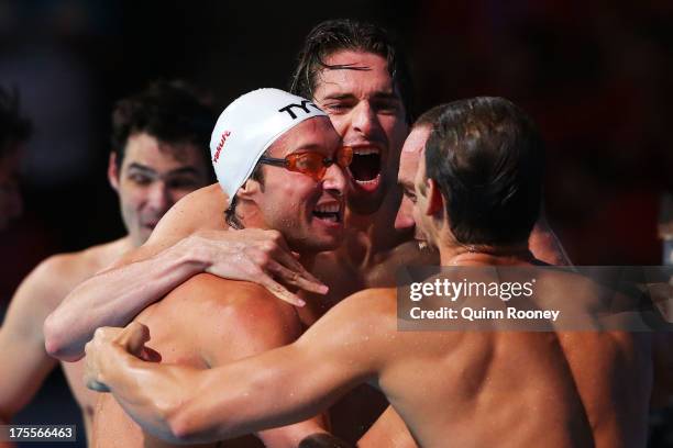 Camille Lacourt, Giacomo Perez-Dortona, Fabien Gilot and Jeremy Stravius of France celebrate after the USA are disqualified and they are instated as...