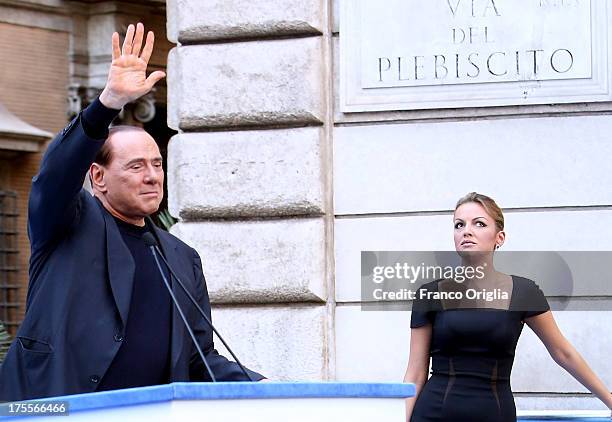 Former Prime Minister Silvio Berlusconi, flanked by his new girlfriend Francesca Pascale, waves to his supporters during a Pro-Berlusconi rally...