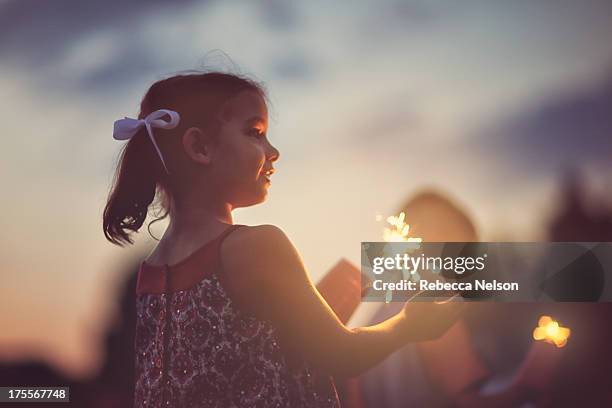 little girl with sparkler - sparkler stock pictures, royalty-free photos & images