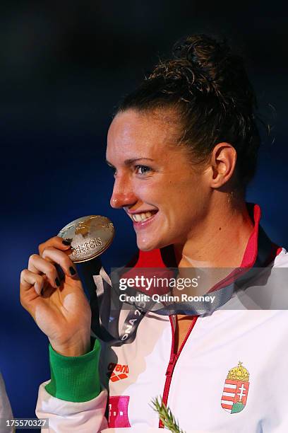 Gold medal winner Katinka Hosszu of Hungary celebrates on the podium after the Swimming Women's Individual Medley 400m Final on day sixteen of the...