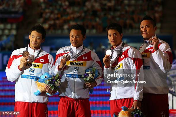 Bronze medal winners Ryosuke Irie, Kosuke Kitajima, Takuro Fujii and Shinri Shioura of Japan celebrate on the podium after the Swimming Men's Medley...