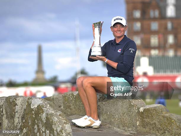 Golfer Stacy Lewis poses with the trophy on the Swilcan Bridge after winning the women's British Open Golf Championship at the Old Course in St...