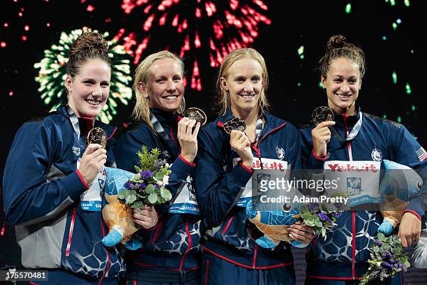 Gold medal winners Missy Franklin, Jessica Hardy, Dana Vollmer and Megan Romano of the USA celebrate on the podium after the Swimming Women's Medley...