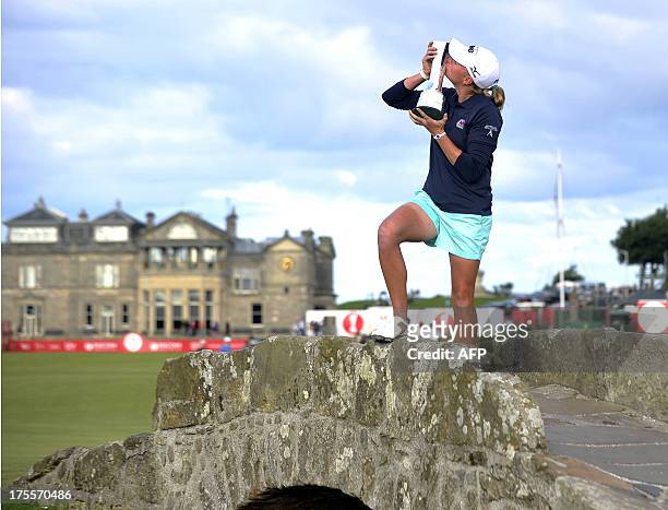 Golfer Stacy Lewis kisses the trophy on the Swilcan Bridge after winning the women's British Open Golf Championship at the Old Course in St Andrews,...