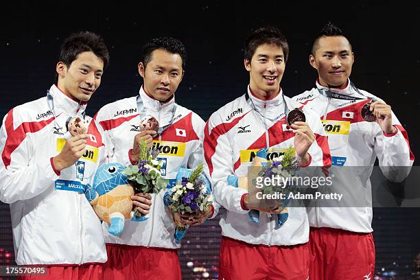 Bronze medal winners Ryosuke Irie, Kosuke Kitajima, Takuro Fujii and Shinri Shioura of Japan celebrate on the podium after the Swimming Men's Medley...