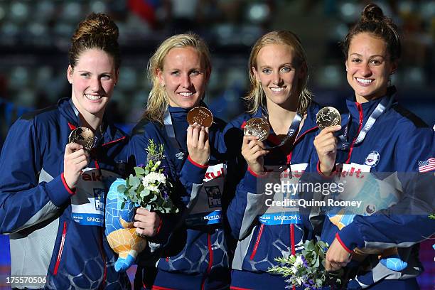 Gold medal winners Missy Franklin, Jessica Hardy, Dana Vollmer and Megan Romano of the USA celebrate on the podium after the Swimming Women's Medley...