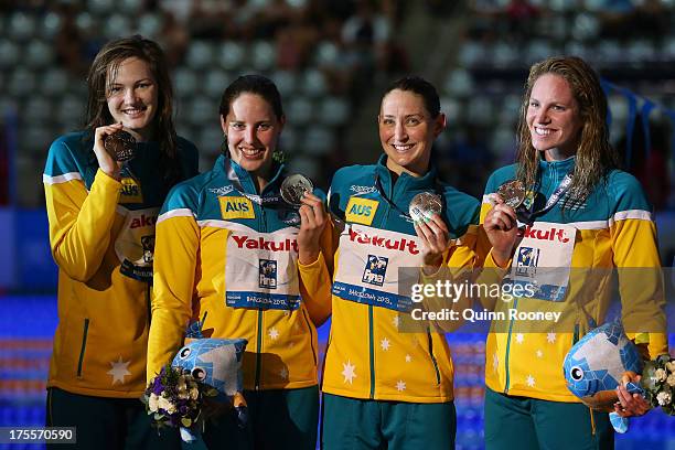 Silver medal winners Emily Seebohm, Sally Foster, Cate Campbell and Alicia Coutts celebrate on the podium after the Swimming Women's Medley 4x100m...