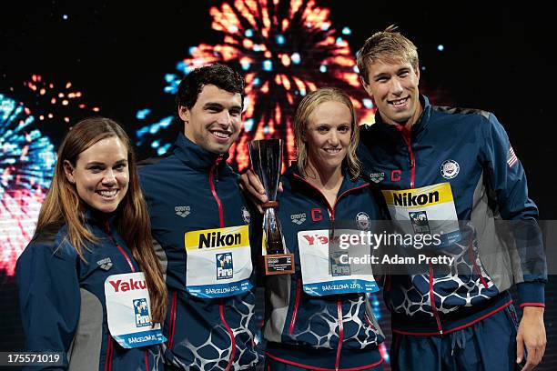 Natalie Coughlin, Ricky Berens, Dana Vollmer and Matt Greevers of the USA celebrate on the podium as they accept the award for 'Best Team' on day...