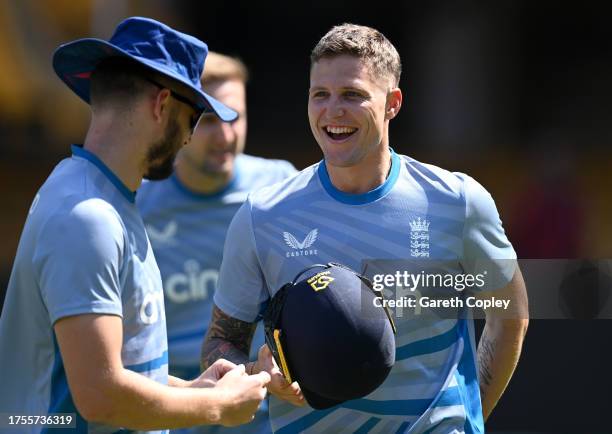 Brydon Carse of England speaks with Gus Atkinson during nets session at Karnataka State Cricket Association Stadium on October 25, 2023 in Bangalore,...