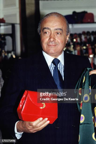 Egyptian businessman Mohamed Al Fayed with a bag designed by Paloma Picasso in 1989 ca. In London, England.