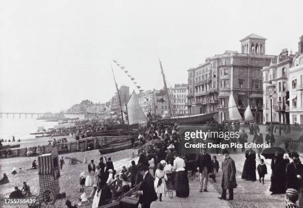 Hastings, East Sussex, England, showing the promenade and the pier in the 19th century. From Around The Coast, An Album of Pictures from Photographs...