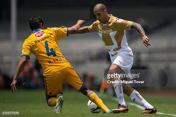 Jose Francisco Torres drives the ball during a match between Pumas and Tigres as part of the league MX at Olympic stadium, on August 04, 2013 in...