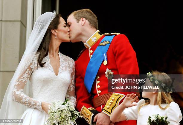 Britain's Prince William and his wife Kate, Duchess of Cambridge, kiss on the balcony of Buckingham Palace in London, following their wedding at...