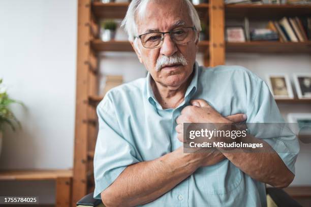 senior man having a pain in his chest - condition stock pictures, royalty-free photos & images