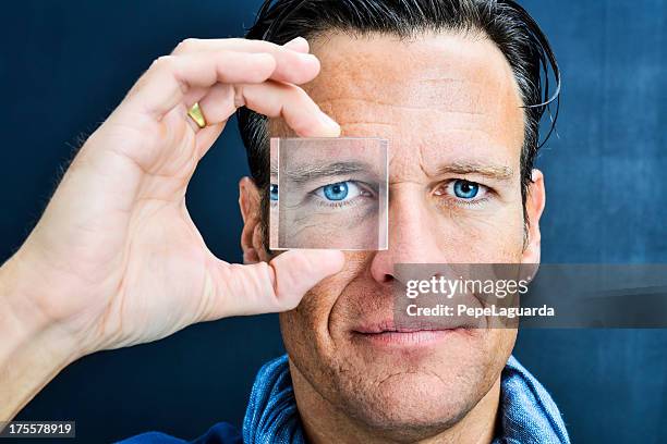 vision: man looking through lens - looking through an object stock pictures, royalty-free photos & images