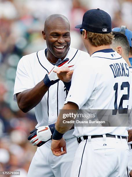 Torii Hunter of the Detroit Tigers celebrates with Andy Dirks after hitting the game-winning single in the 12th inning to drive in Matt Tuiasosopo to...