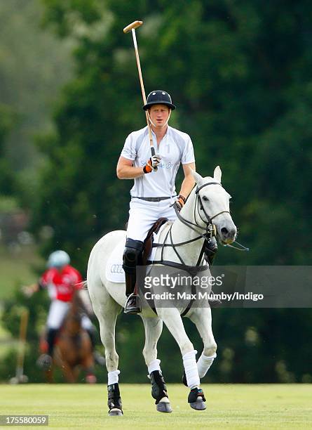 Prince Harry plays in the Audi Polo Challenge at Coworth Park Polo Club on August 4, 2013 in Ascot, England.