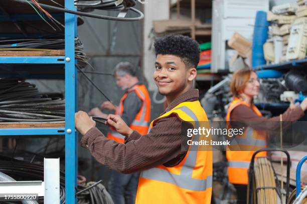 gen z recycling worker standing in warehouse - praktikant bildbanksfoton och bilder