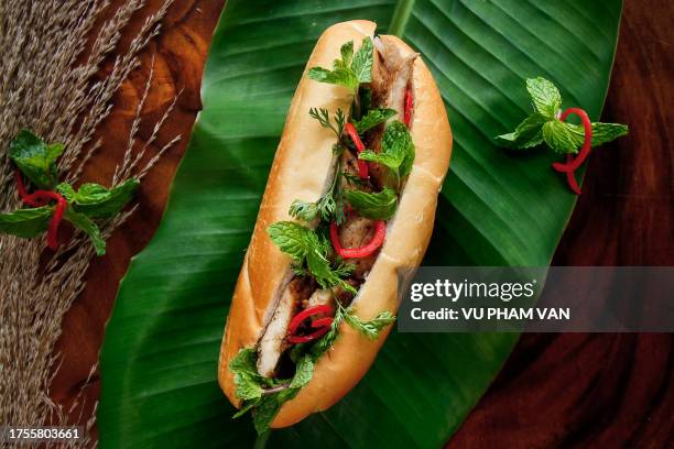 vietnamese banh mi sandwich stuffed with pork and mint leaves - vietnamese mint stock pictures, royalty-free photos & images