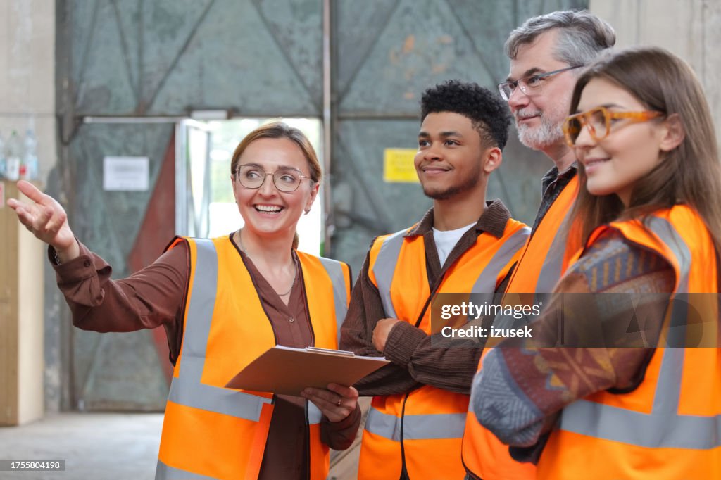 Group of recycling coworkers in warehouse