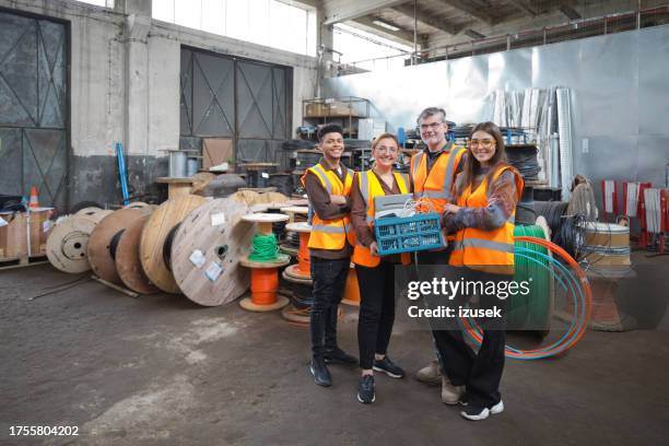 group of recycling coworkers in warehouse - industrial storage bins stockfoto's en -beelden