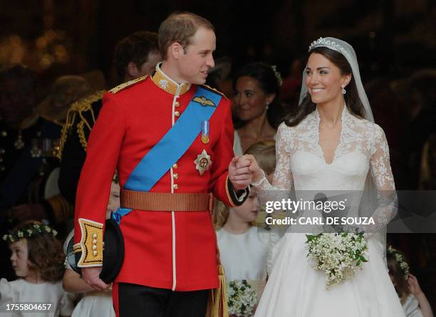 Britain's Prince William and his wife Kate, Duchess of Cambridge, look at each other as they come out of Westminster Abbey following their wedding...