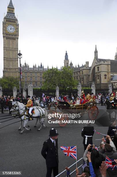 Britain's Prince William and his wife Kate, Duchess of Cambridge, travel in the 1902 State Landau carriage along the Processional Route with a...