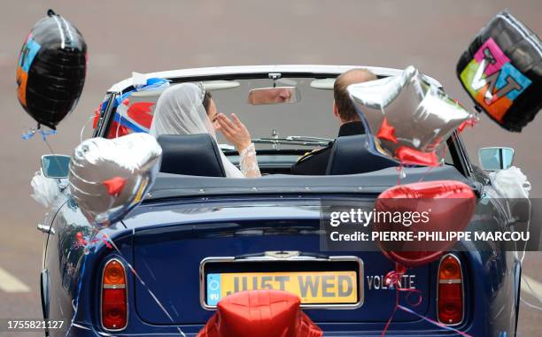 Britain's Prince William drives an Aston Martin as he leaves the Buckingham Palace with his wife Kate, Duchess of Cambridge, after their wedding...