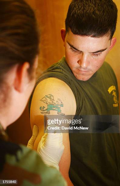 Marine Sgt. Michael J. McMahon, of the 1st Force Service Support Group, receives a vaccination against smallpox January 31, 2003 at Camp Pendleton,...