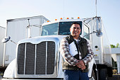 Hispanic truck driver with clipboard
