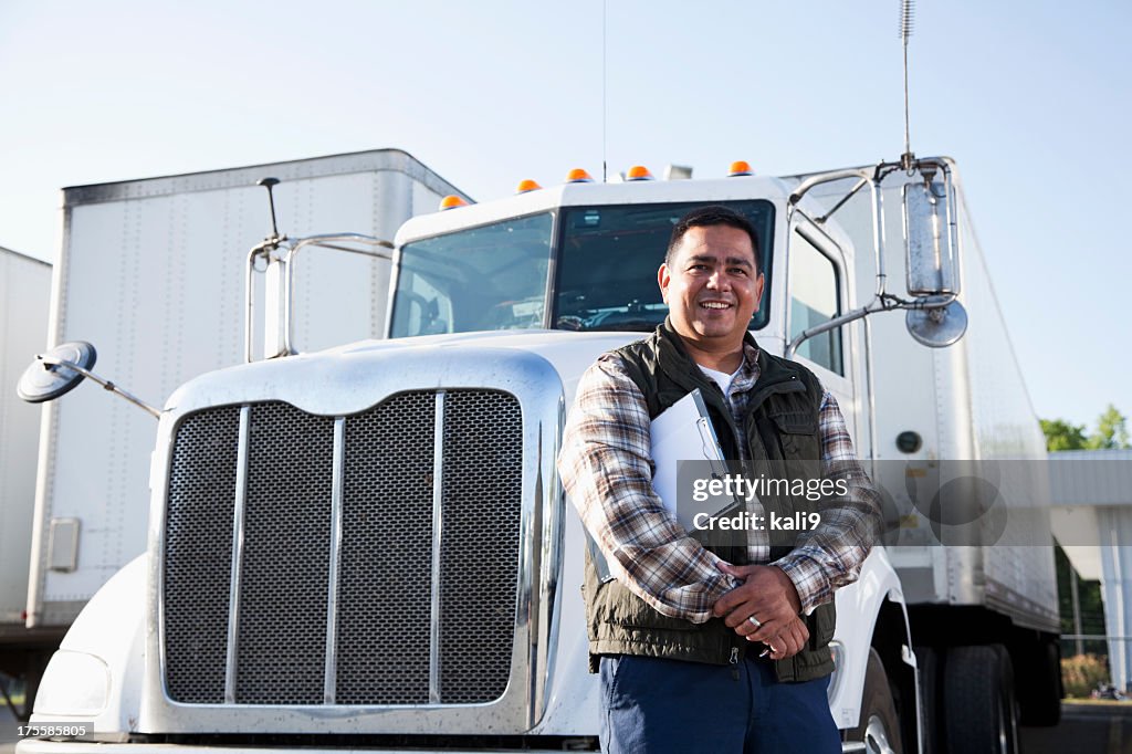 Hispanic truck driver with clipboard