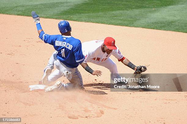 Emilio Bonifacio of the Toronto Blue Jays slides safely into second past Erick Aybar of the Los Angeles Angeles of Anaheim on a single hit by Maicer...