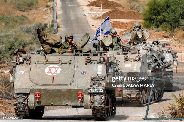 Israeli army tracked medical vehicles move along a road near the northern town of Kiryat Shmona close to the border with Lebanon on October 31, 2023...