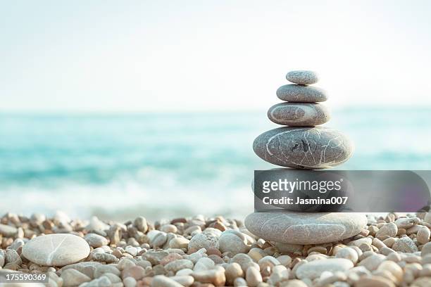 pebble on beach - meditation stock pictures, royalty-free photos & images