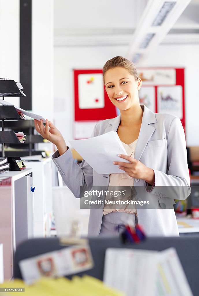 Businesswoman Keeping Documents In Paper Tray