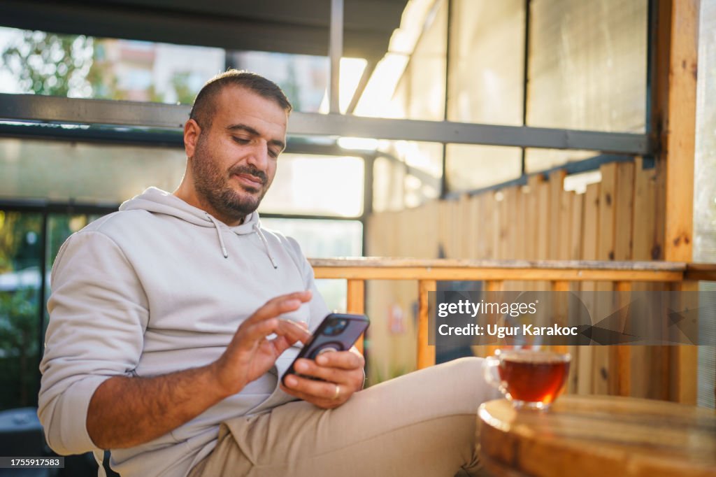 Man using mobile phone at the cafe